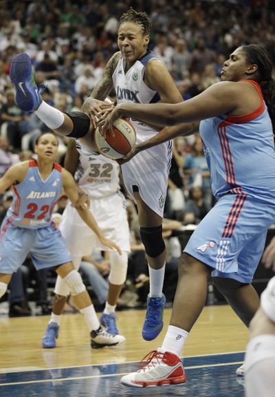 Seimone Augustus fights for the ball against Courtney Paris, right. (Associated Press)