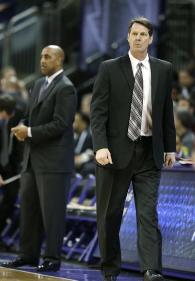 WSU coach Ken Bone, right, and UW’s Lorenzo Romar square off. (Associated Press)