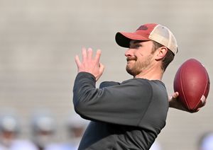 Former WSU quarterback Luke Falk throws during an impromptu competition with then-QB Cam Ward at the Crimson and Gray game on April 23, 2022 at Gesa Field. (Tyler Tjomsland/The Spokesman-Review)
