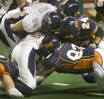 
The Spokane Shock defense swarms around Bakersfield quarterback Bobby Pesavento Saturday to stop a first-half drive. 
 (Christopher Anderson / The Spokesman-Review)