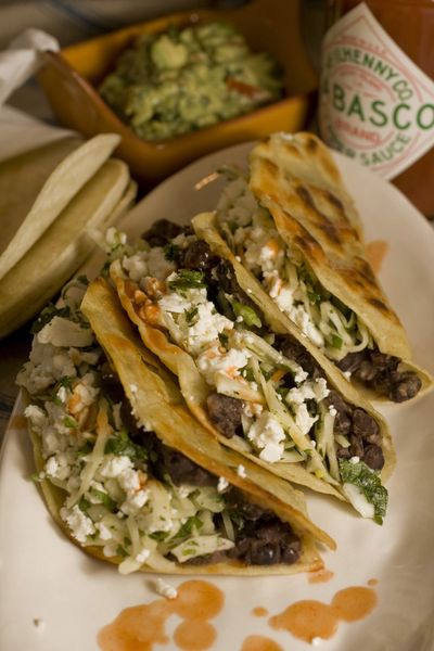 Crispy Black Bean Tacos with Feta and Cabbage Slaw  made at home are every bit as tasty as take-out tacos.  (Associated Press / The Spokesman-Review)