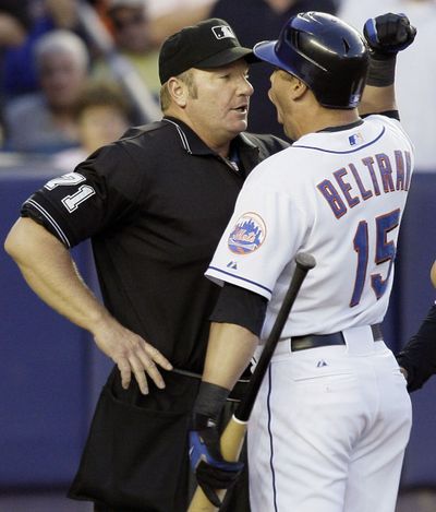 Umpire Brian Runge, left, has been behind the plate for two no-hitters this season and three in his career. (Associated Press)