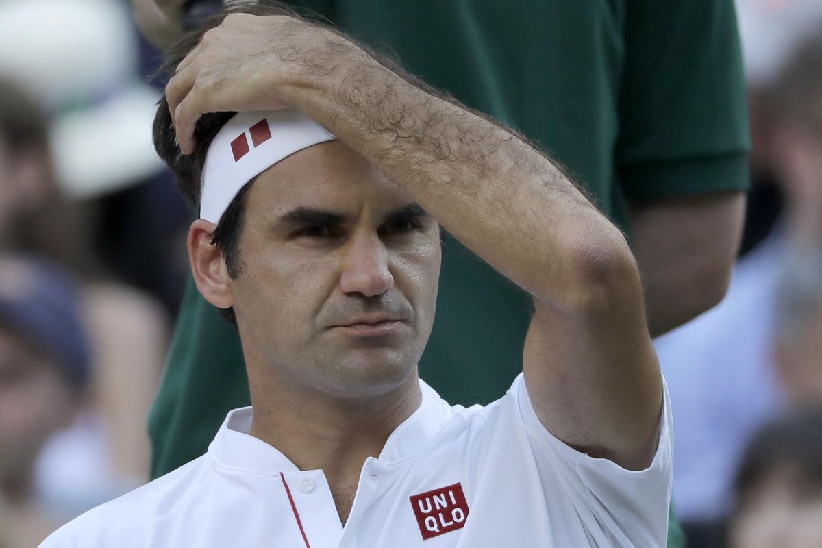 Switzerland's Roger Federer sits during a break in the fifth set of his men's quarterfinals match against Kevin Anderson of South Africa, at the Wimbledon Tennis Championships, in London, Wednesday July 11, 2018. (Ben Curtis / AP)