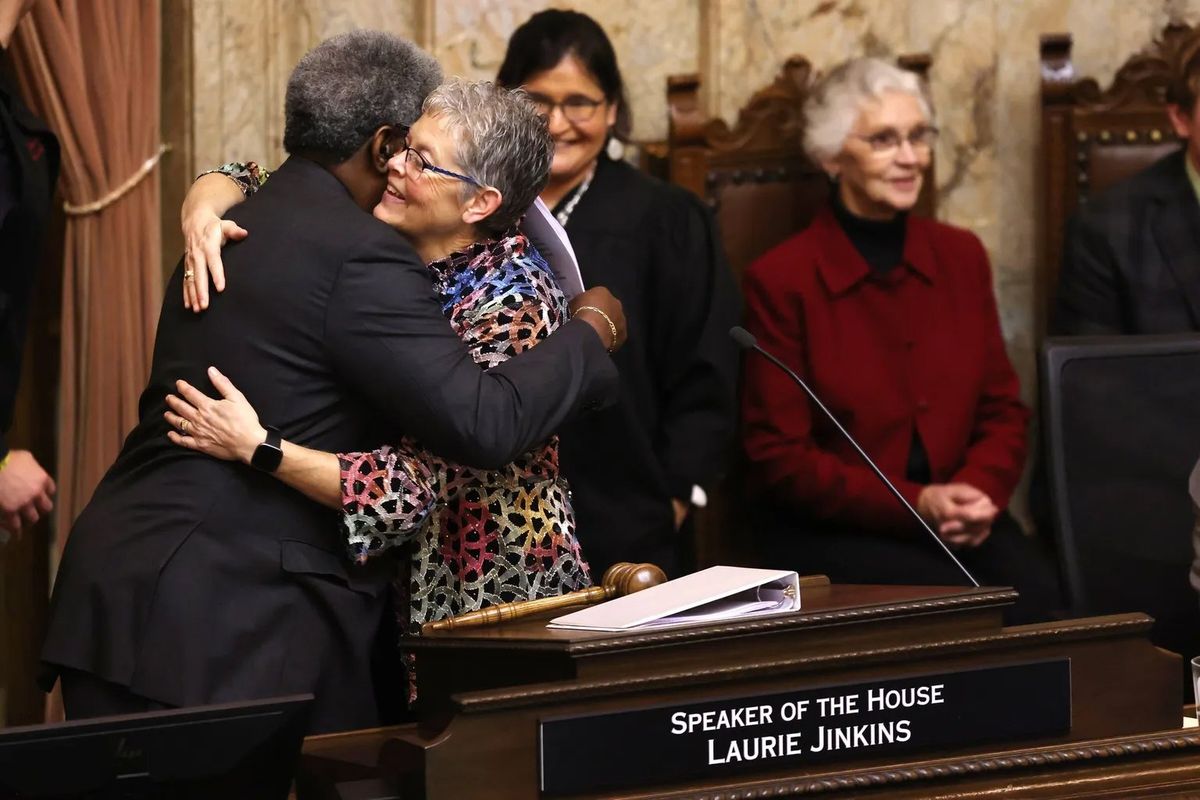 Speaker of the House Laurie Jinkins, D-Tacoma, hugs pastor Gregory Christopher, of the Shiloh Baptist Church in Tacoma, on Monday as the new legislative session opened.  (Karen Ducey/Seattle Times)