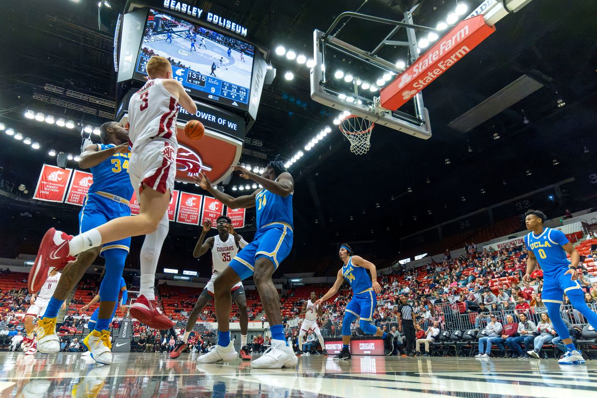 Washington State guard Jabe Mullins, left, passes to Mouhamed Gueye during the first half Friday at Beasley Coliseum in Pullman.  (Geoff Crimmins/FOR THE SPOKESMAN-REVIEW)