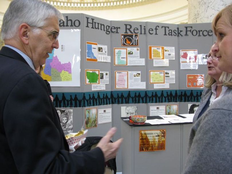 Rep. George Sayler, D-Coeur d'Alene, left, talks with anti-hunger activists at 