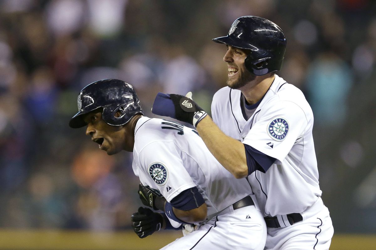 Austin Jackson, left, and Chris Taylor celebrate the M’s win. (Associated Press)