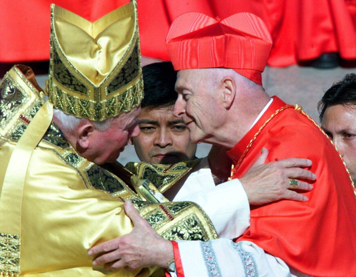 FILE - In this Feb. 21, 2001 file photo, Cardinal Theodore Edgar McCarrick, archbishop of Washington D.C., wearing the three-cornered biretta hat, embraces Pope John Paul II in St. Peter