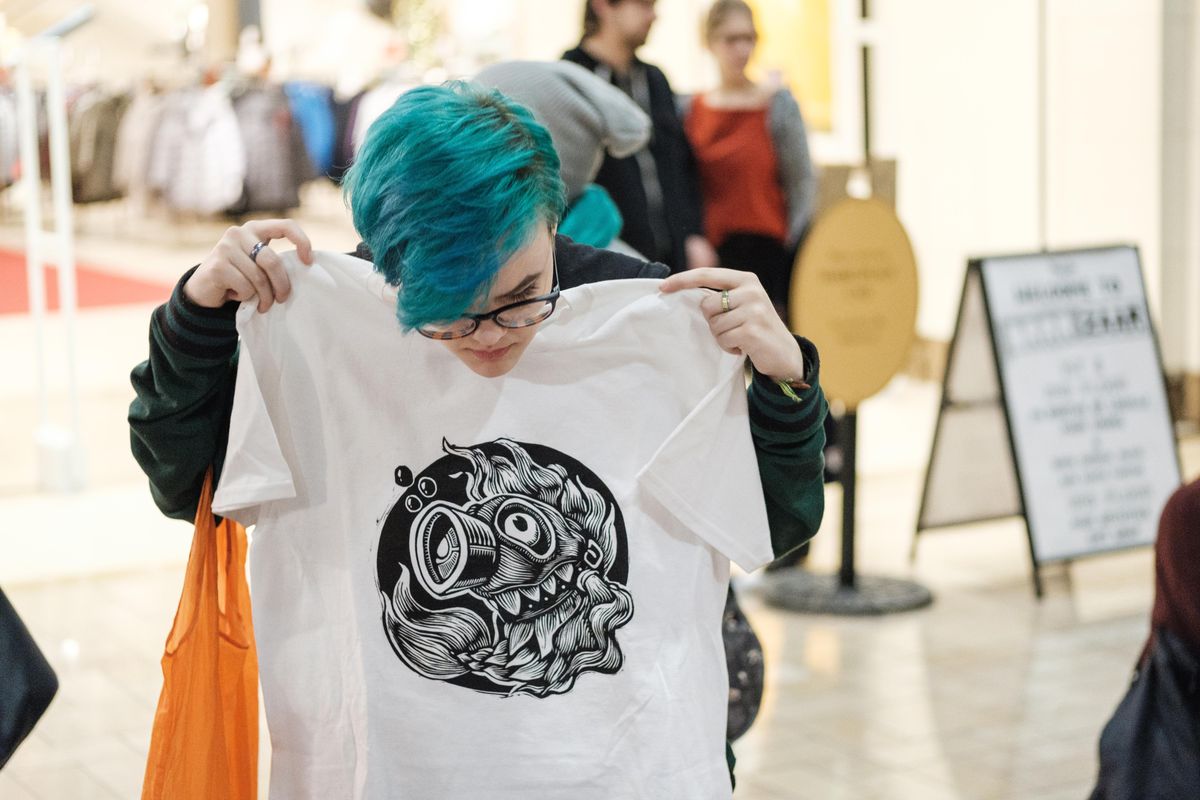 A shopper checks out a T-shirt at the 2018 Brrrzaar. Terrain is bringing the winter art festival back to River Park Square on Saturday. (Terrain)