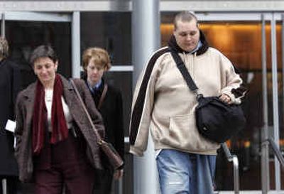 
Jeffrey Lee Parson leaves court in Seattle on Friday with his lawyers, Carol Koller, left, and Nancy Tenney, following his sentencing in the Blaster Internet worm case. 
 (Associated Press / The Spokesman-Review)