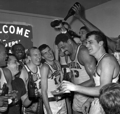 Wilt Chamberlain gets champagne poured on him as the 76ers celebrate winning the Eastern Division championship in 1967. (Associated Press)