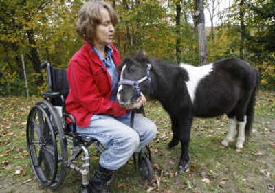 
Patty Cooper sits in her wheelchair with her miniature horse, Earl, in Warren, Vt. Associated Press
 (File Associated Press / The Spokesman-Review)