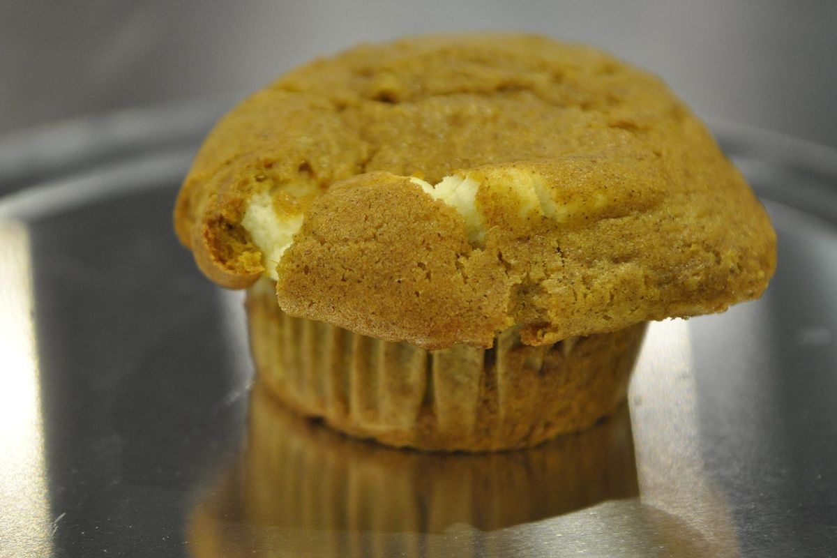 This pumpkin muffin from Lilac City Bakery and Celebrations Sweet Boutique, both owned by Amber and Joe Owens, features a creamy swirl. (Adriana Janovich / The Spokesman-Review)