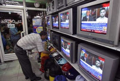 
A Palestinian man watches  President Bush and Hamas spokesman Sami Abu Zuhri on an Arabic news channel in an electronics shop Monday in Gaza City. Associated Press
 (Associated Press / The Spokesman-Review)