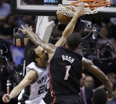 Heat center Chris Bosh can’t stop Spurs guard Manu Ginobili from dunking during the first half. (Associated Press)