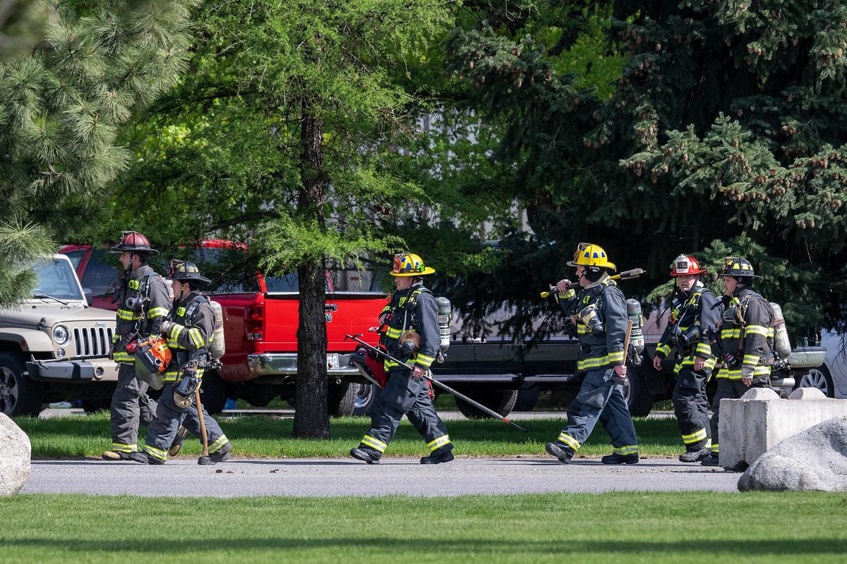 Firefighters arrive at Inland Paper Company as reports of a fire and hazardous material was ongoing early afternoon Wednesday at the plant in Millwood.  (COLIN MULVANY/THE SPOKESMAN-REVIEW)