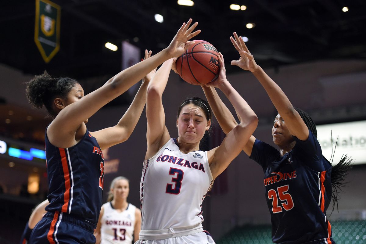 Gonzaga forward Jenn Wirth (3) is double teamed by Pepperdine forward Tylinn Carter (on left) and Pepperdine forward Yasmine Robinson-Bacote (25) during the second half of a West Coast Conference Basketball Championships women