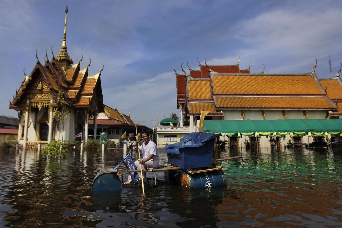 A Thai man rides a makeshift watercraft with a sofa installed on it in a flooded compound of a temple in Bangkok, Thailand, Wednesday, Nov. 9, 2011. The flooding began in late July and the water has reached parts of Bangkok, where residents are frustrated by government confusion over how much worse the flooding will get. (Associated Press / Associated Press)