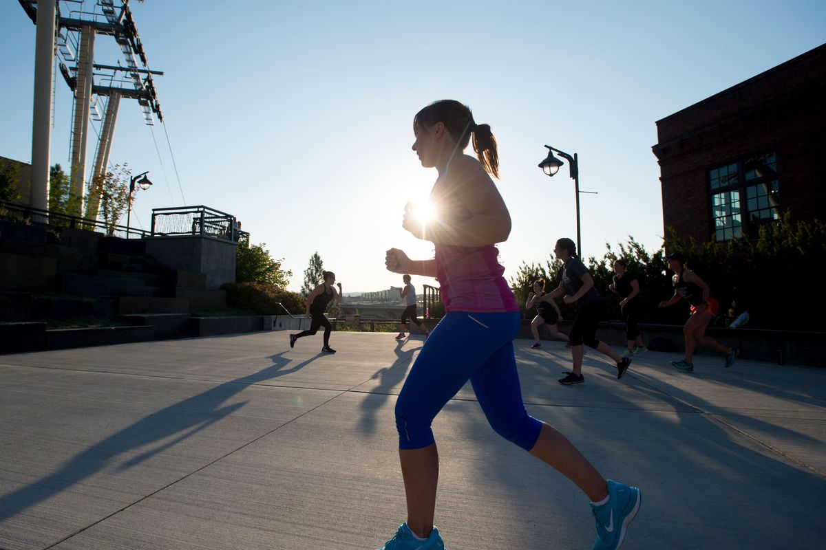 Elisabeth Hooker works out with others during a free evening workout session sponsored by Downtown Spokane and Numerica Credit Union on Tuesday, July 11, 2017, at the Tribal Gathering Place next to City Hall in Spokane, Wa. (Tyler Tjomsland / The Spokesman-Review)