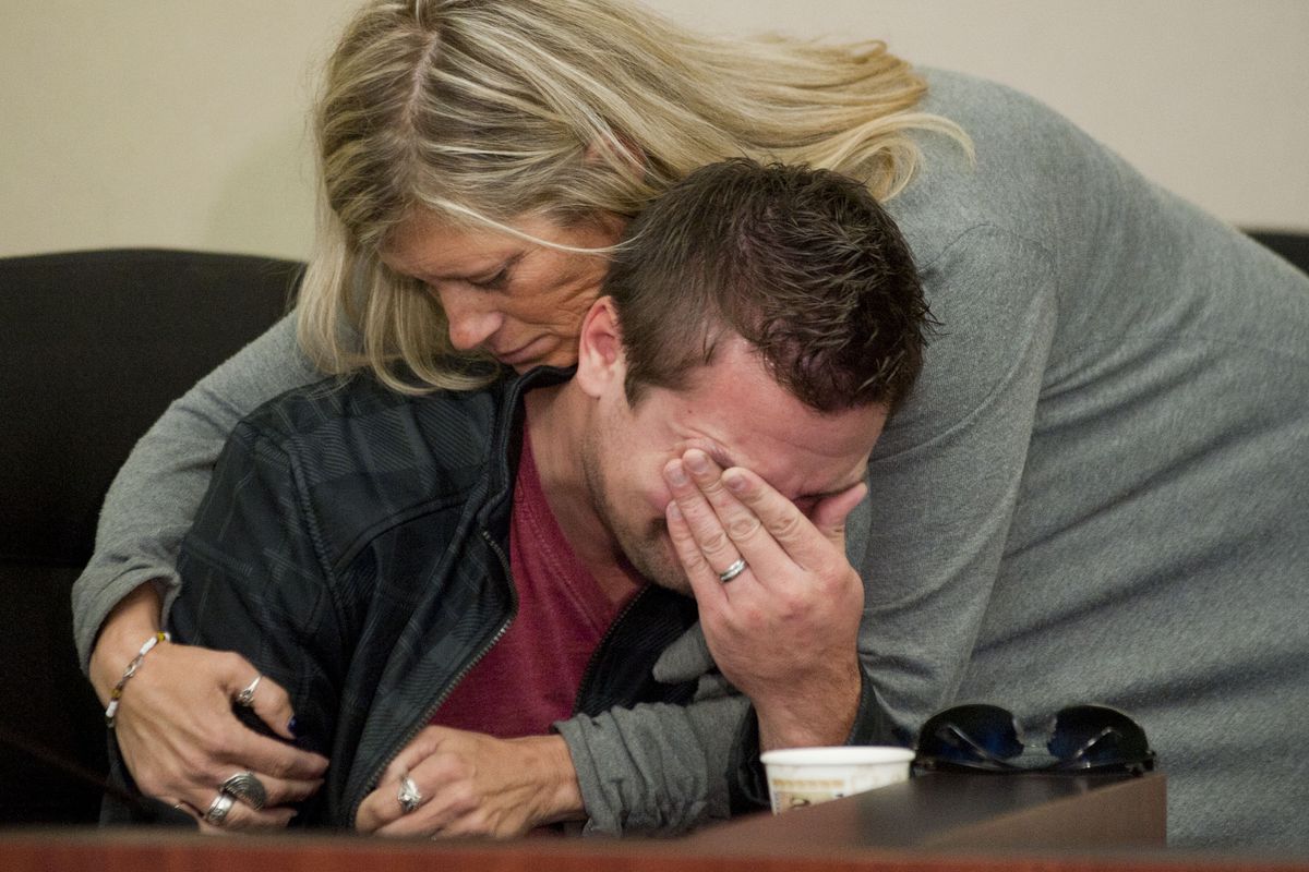 GRESHAM, OREGON - October 18, 2012 -  Clint Heichel gets a hug from Lorilei Ritmiller, mother of Whitney Heichel, as he breaks down after he attempted to speak at a news conference Thursday Oct. 18, 2012 in the council chambers for the City of Gresham. (Brent Wojahn / The Oregonian)