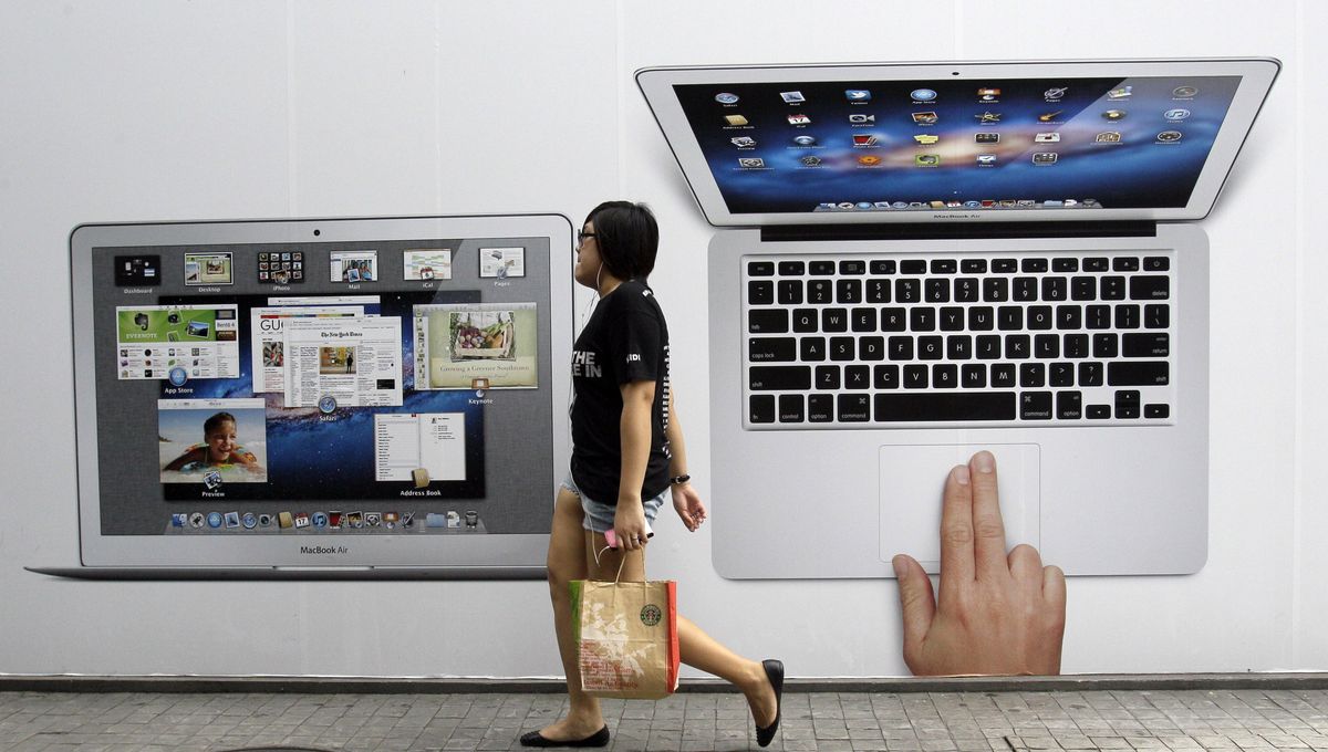 A Thai girl walks past an advertisement for an Apple retail store in Bangkok, Thailand. Apple co-founder Steve Jobs died last Wednesday at the age of 56. (Associated Press)