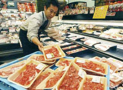 
A supermarket employee removes packaged U.S. beef imports from shelves, last year in Kyoto, Japan.  
 (Associated Press / The Spokesman-Review)
