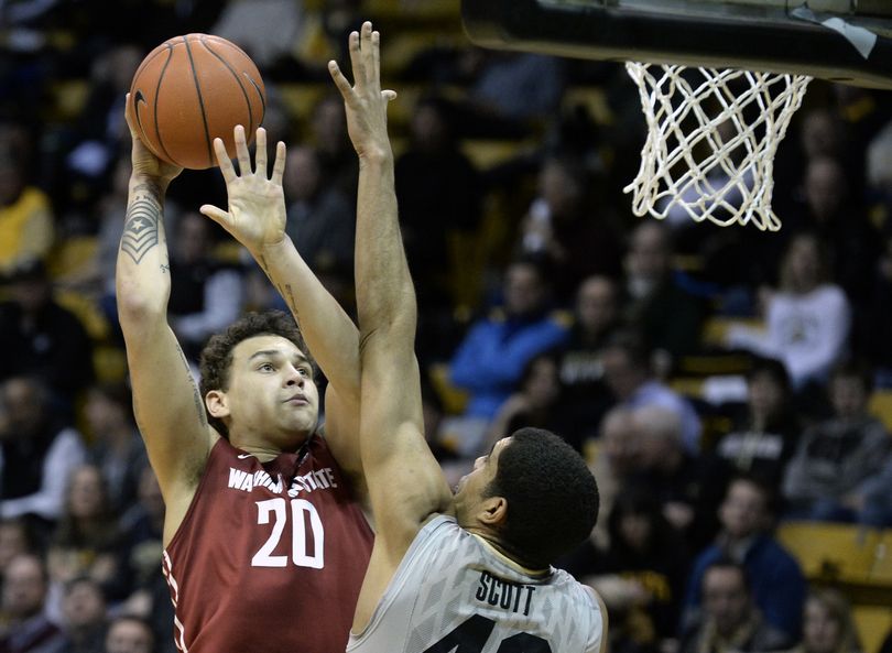 Washington State’s Jordan Railey shoots over Colorado’s Josh Scott. (Associated Press)