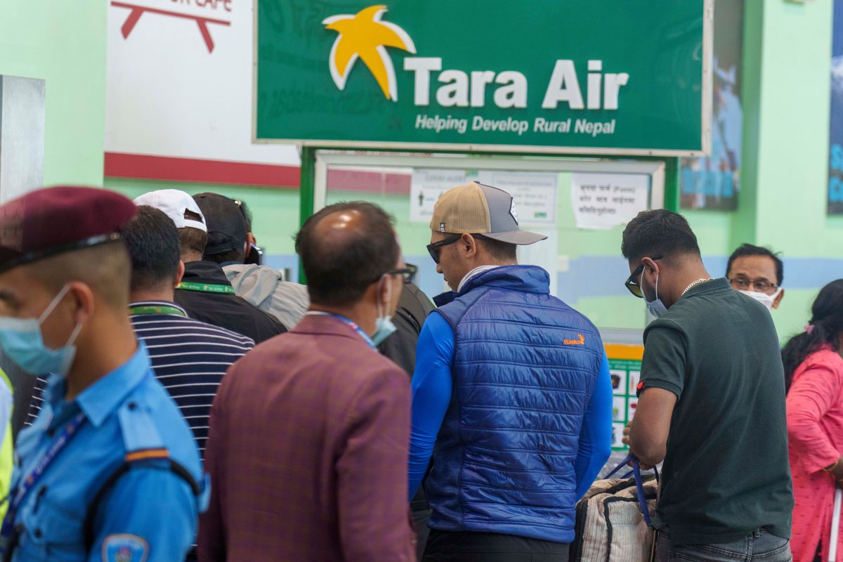 A signage of Tara Airlines is seen behind as a team of climbers prepare to leave for rescue operations from the Tribhuvan International Airport in Kathmandu, Nepal, Sunday, May 29, 2022. A small airplane with 22 people on board flying on a popular tourist route was missing in Nepal’s mountains on Sunday, an official said. The Tara Airlines plane, which was on a 15-minute scheduled flight to the mountain town of Jomsom, took off from the resort town of Pokhara, 200 kilometers (125 miles) east of Kathmandu. It lost contact with the airport tower shortly after takeoff.  (Niranjan Shreshta)