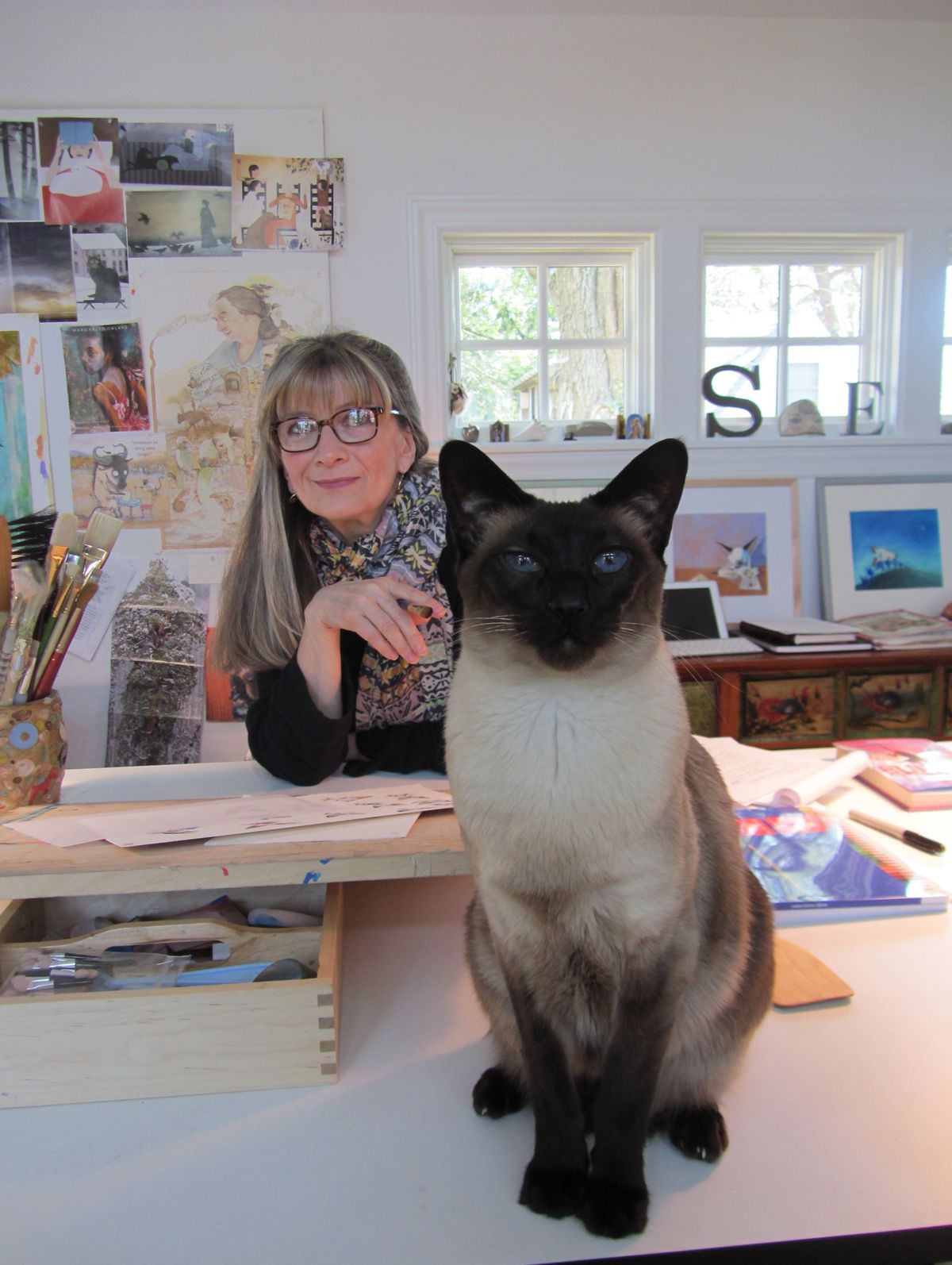 Judy Schachner, shown with cat Skippy, will give two area readings from her new book, “Dewey Bob,” below.