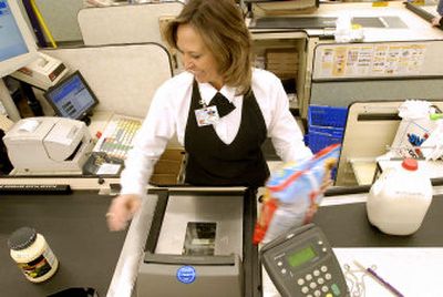 
Kelli Ormesher scans grocery items at Super 1 Foods in Coeur d'Alene in January. Gov. Butch Otter proposed a targeted grocery tax credit to give a big credit to low-income Idahoans, but lawmakers on the House tax committee rejected it in favor of a pricier proposal from Rep. Cliff Bayer, R-Boise, to raise the credit for everyone.  
 (Jesse Tinsley / The Spokesman-Review)