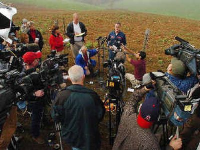 
Air safety investigator Brian Rayner speaks to the media at fog-covered Bull Mountain, the crash site of the Hendrick plane.
 (Associated Press / The Spokesman-Review)
