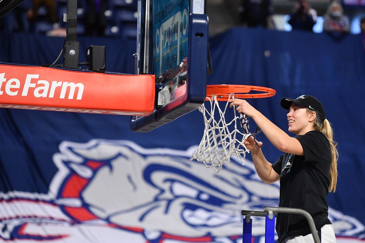 Gonzaga Bulldogs guard Jill Townsend (32) cuts down a net during a Senior Night and net cutting celebration following the second half of a college basketball game against LMU on Saturday, February 27, 2021, at McCarthey Athletic Center in Spokane, Wash.  (Tyler Tjomsland/The Spokesman-Review)