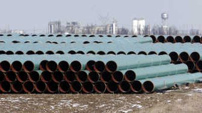 
Pipe for a new gas pipeline sits in a field near Illiopolis, Ill.,  on Feb. 27. The pipe will be used in the construction of the 1,678-mile Rockies Express pipeline from Meeker, Colo., to Clarington, Ohio. Associated Press
 (Associated Press / The Spokesman-Review)