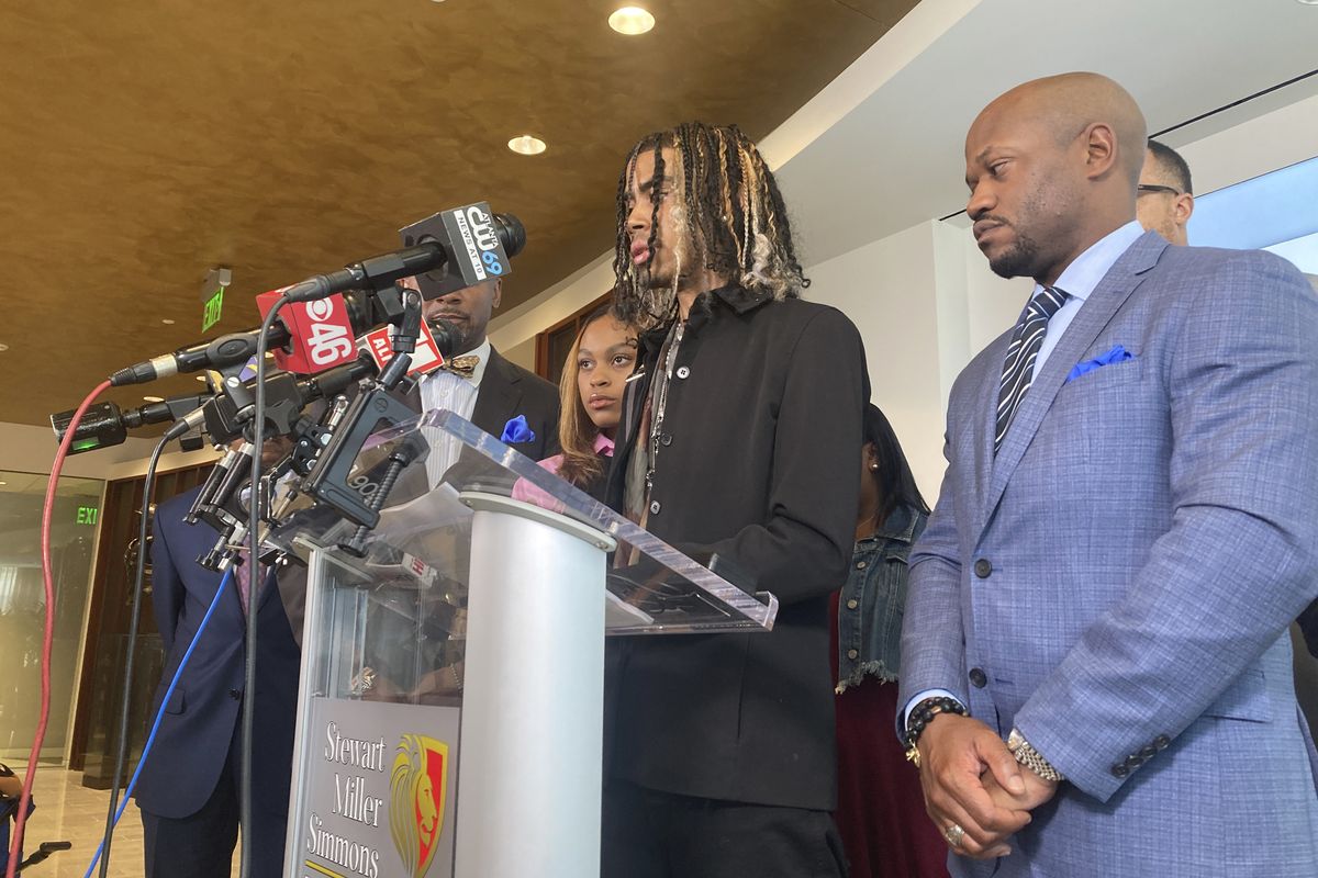 Messiah Young speaks during a news conference accompanied by attorney L. Chris Stewart, right, who represents plaintiff Taniyah Pilgrim, background center, in Atlanta on Thursday, June 17, 2021. Young and Pilgrim were pulled from their car on May 30, 2020 by Atlanta police and are suing the city and officers for excessive force. Atlanta police had no justification for pulling the two students from their car and hitting them with stun guns while they were stuck in traffic caused by protests over George Floyd