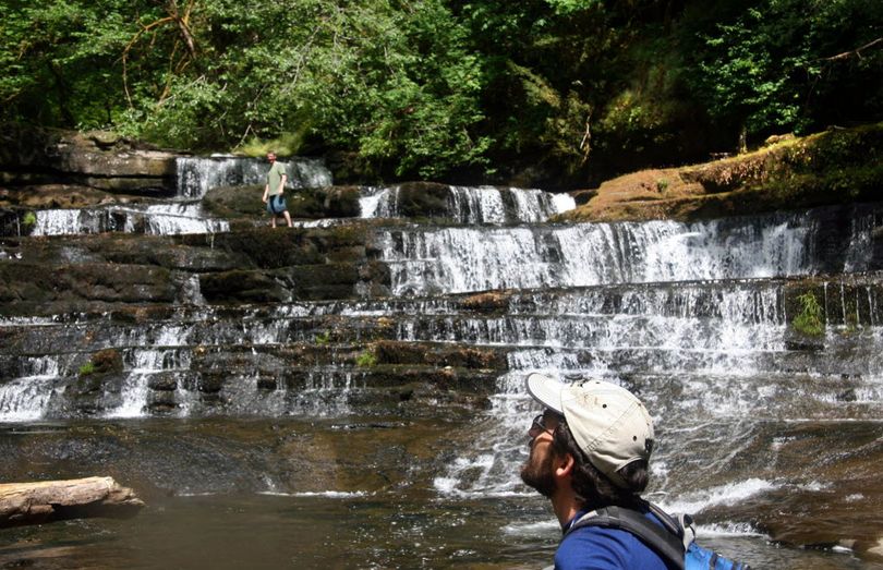 In this June 2, 2009 file photo, Josh Laughlin, foreground, conservation director with Cascadia Wildlands, visits the waterfall that is the centerpiece of the Devil's Staircase wilderness proposal on the Siuslaw National Forest in Oregon's Coast Range. Legislation has been reintroduced in the U.S. Senate to designate the area as wilderness, along with other areas around the state. (Associated Press)