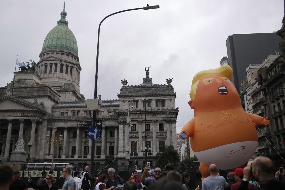 Opponents to the G20 summit carry a giant inflatable doll depicting U.S. President Donald Trump wearing a diaper in front of Congress in Buenos Aires, Argentina, on Thursday, Nov. 29, 2018. Leaders from the Group of 20 industrialized nations will meet in Buenos Aires for two days starting Friday. (Sebastian Pani / AP)