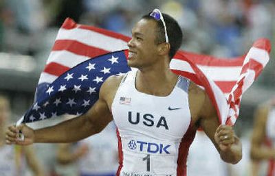 
Bryan Clay celebrates with the Stars and Stripes, after winning gold in the decathlon.
 (Associated Press / The Spokesman-Review)