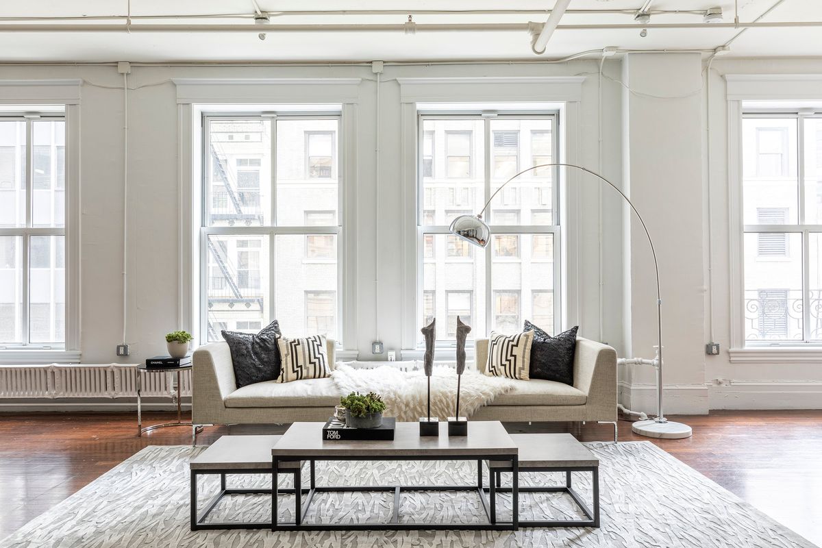 Architecture and space speak to the heart of how a room should be laid out in addition to the type of furniture that should be used. Two backless chaises serve as a sofa in a living room with large, over-sized windows. (Handout/TNS)  (Handout/TNS)