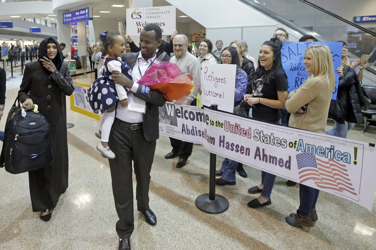 This Feb. 10, 2017, photo, Abdisellam Hassen Ahmed, a Somali refugee who had been stuck in limbo after President Donald Trump temporarily banned refugee entries, walks with his wife Nimo Hashi, and his 2-year-old daughter, Taslim, who he met for the first time after arriving at Salt Lake City International Airport. Refugee advocates, including faith-based groups that President Donald Trump is courting in his re-election bid, called on Congress Thursday, Oct. 1, 2020, to halt his administration’s plans to slash the limit on refugees allowed into the U.S. to a record low, saying it goes against America’s values.  (Associated Press)