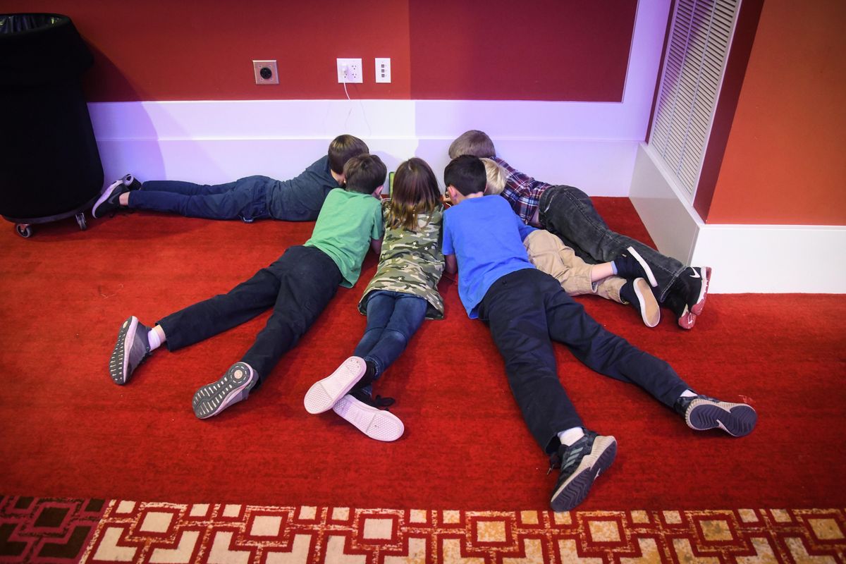 Youngsters play a video game as they wait Tuesday for Cathy McMorris Rodgers to appear  at the Davenport Grand Hotel. (Dan Pelle / The Spokesman-Review)