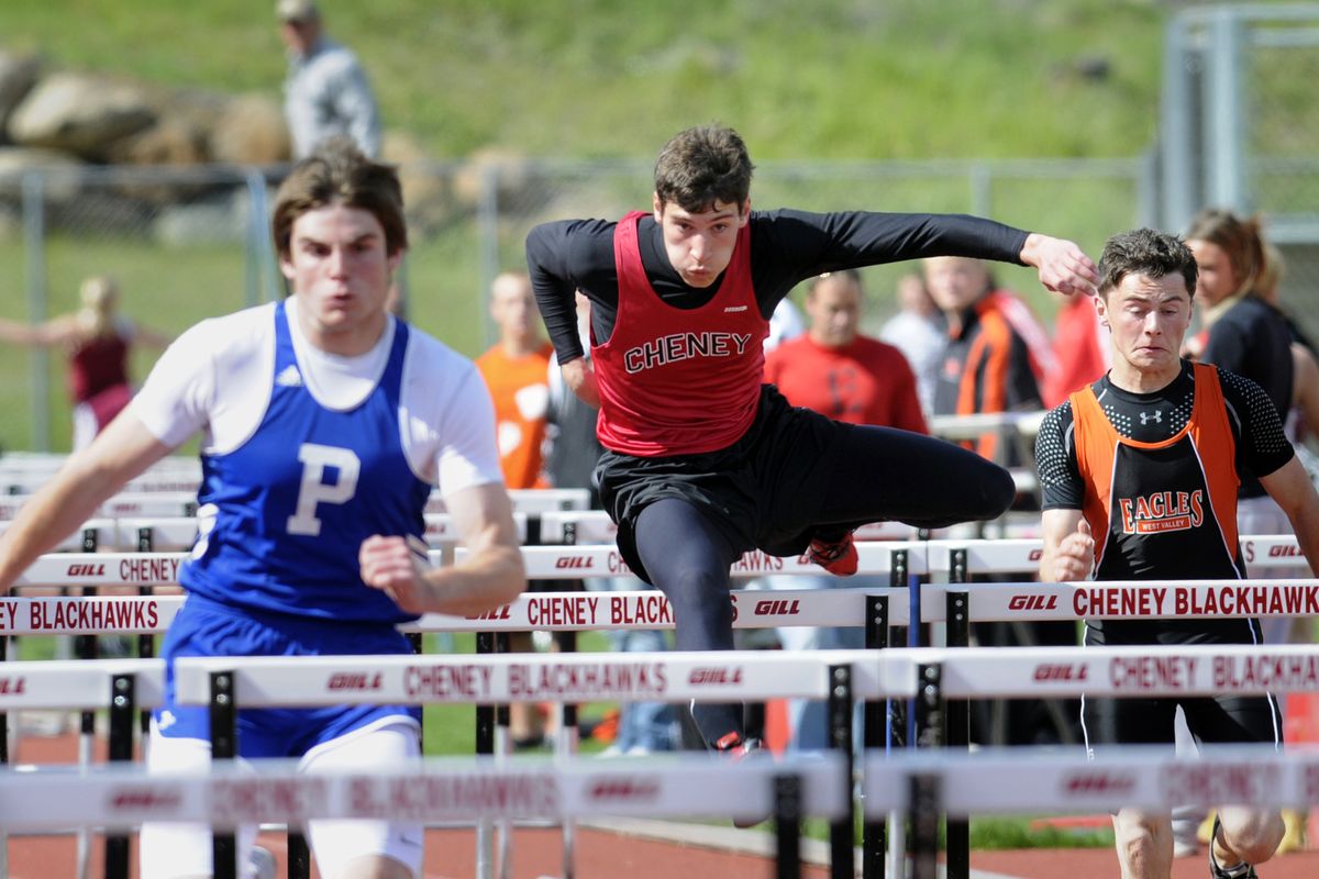 Cheney’s Michael Stralser, center, hurdles toward a state berth at last Saturday’s District 7 2A meet. (Jesse Tinsley)