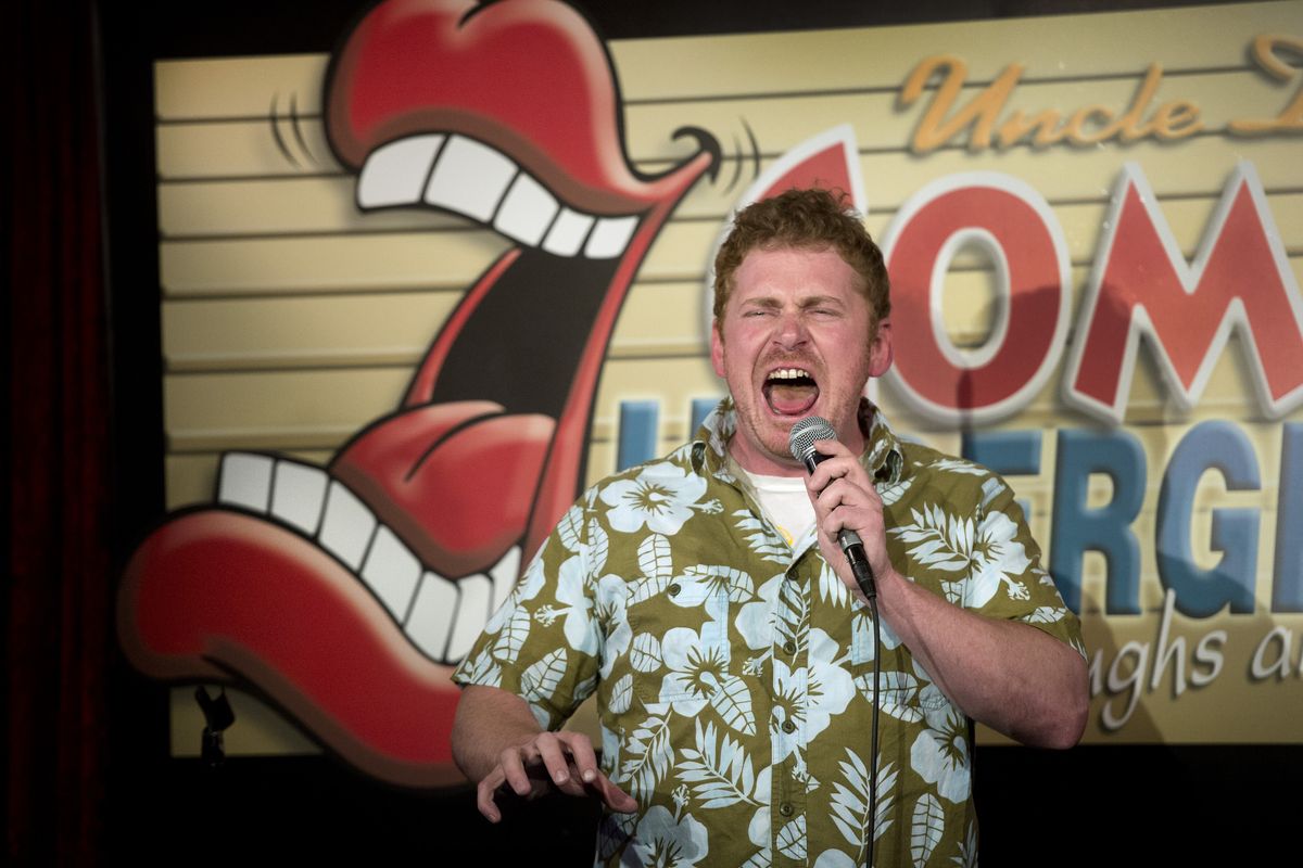 Casey Strain performs an impersonation of actor Arnold Schwarzenegger during a stand-up routine at Uncle D’s Comedy Underground open mic night.