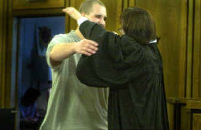 Judge Tari Eitzen, right, hugs Adult Felony Drug Court graduate Chris Rusho during graduation ceremonies in her courtroom Thursday. Ten people graduated from the program Thursday.
(Christopher Anderson/ / The Spokesman-Review)