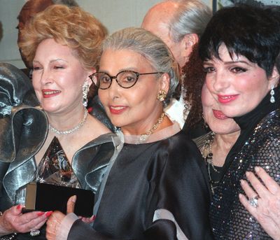 FILE -- In a June 23, 1997 file photo Ginny Mancini, left, and Lena Horne, center, hold  the Ella Award which was given to  Horne, on Monday, June 23, 1997, during the Society of Singers' Lena Horne 80th Birthday Gala in New York.   At right is Liza Minnelli. Singer Lena Horne, who broke racial barriers as a Hollywood and Broadway star famed for her velvety rendition of 