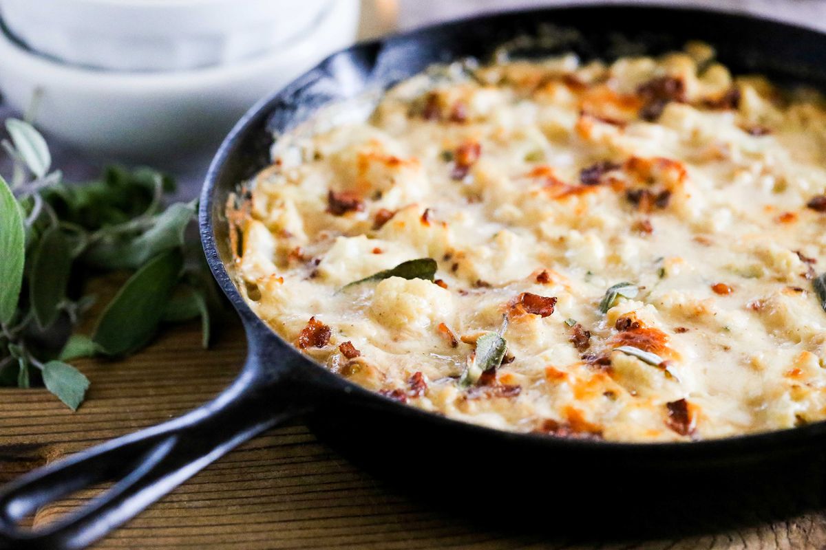 A winter gratin with cauliflower, creamy sage béchamel, bacon bits and melted cheese is a satisfying dish.