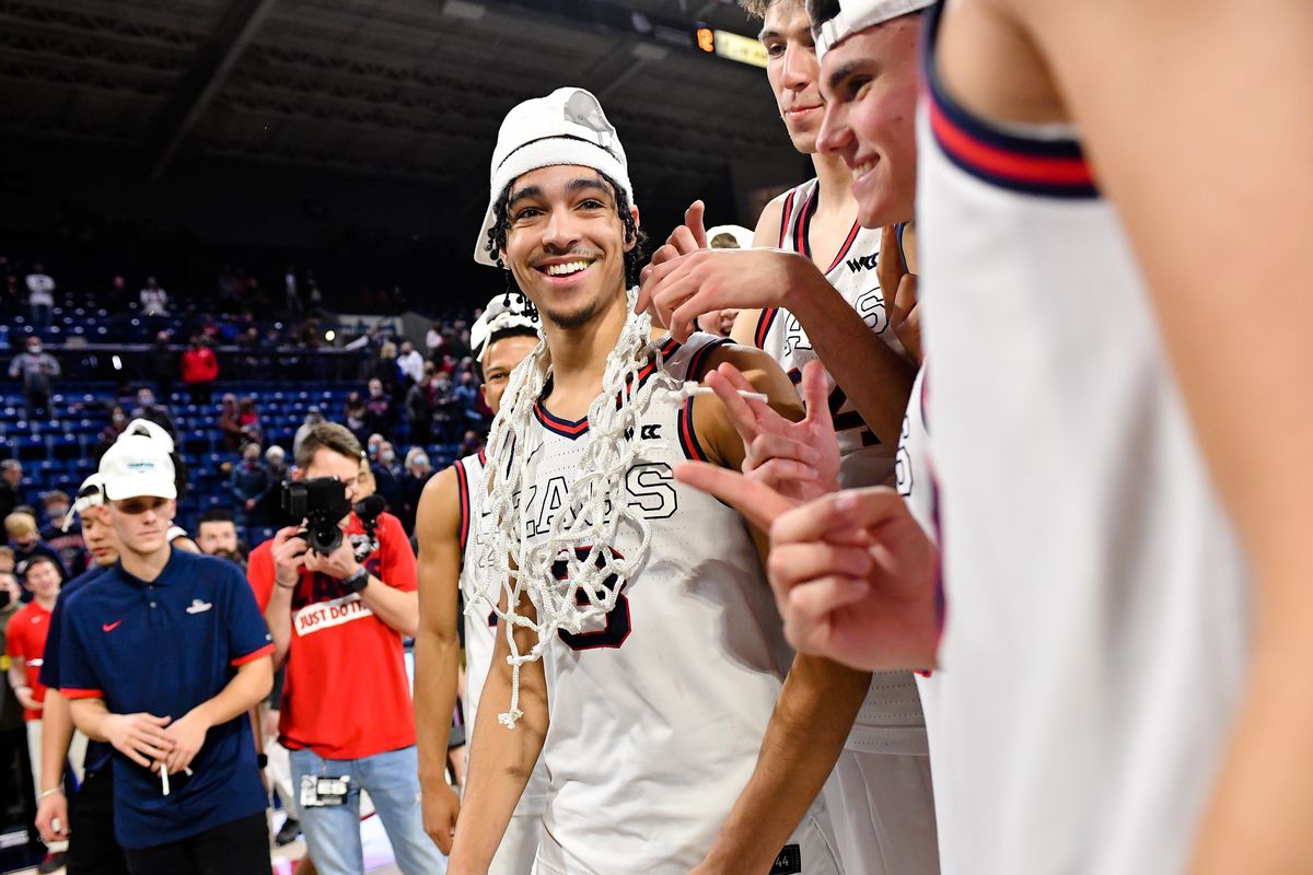 Gonzaga Bulldogs guard Andrew Nembhard (3) wears the net as a necklace after the Bulldogs defeated the Santa Clara Broncos in the second half of a college basketball game on Saturday, Feb 19, 2022, at McCarthey Athletic Center in Spokane, Wash. Gonzaga won the game 81-69.  (Tyler Tjomsland/The Spokesman-Review)