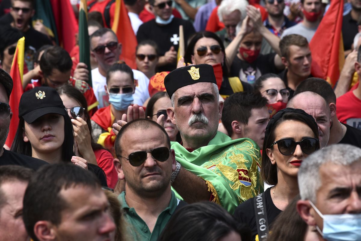 A protester, wearing a traditional hat applauds during a rally in Montenegro