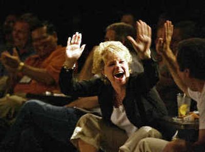 
Employees and clients of the wire-transfer firm IntraNet Inc. laugh during a routine by the Second City improvisation troupe in Chicago where inside jokes about company acronyms and funny impersonations about the company's founder were being performed. 
 (Associated Press / The Spokesman-Review)