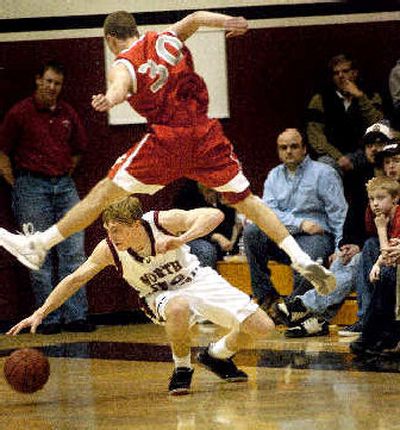 
Ferris' Jon Clift soars over North Central's Eric Beal.
 (Amanda Smith / The Spokesman-Review)