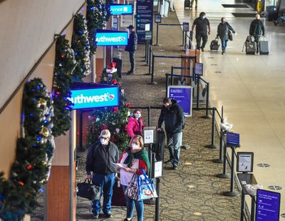 Holiday travelers wait to check in at the Southwest Airlines ticket counters Dec. 23, 2020, at the Spokane International Airport.  (DAN PELLE/THE SPOKESMAN-REVIEW)